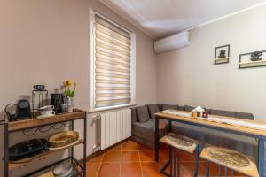a living room with a couch and a table at Ina's Lake Garden Nicolas Suite in Lenno