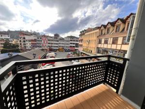 a balcony with a view of a city with buildings at Glitz Hotel in Brinchang