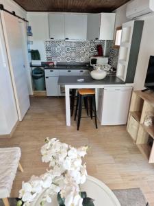 a kitchen with white cabinets and a table at ines in Toulon