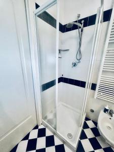 a shower stall in a bathroom with a checkered floor at Mono Ele a Varigotti in Varigotti +36 photos