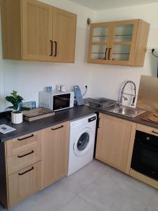 a kitchen with a microwave and a washing machine at Le Baou fully renovated 2025 in Sanary-sur-Mer