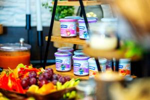 a table with a bunch of vegetables and jars of food at Wellness Hotel Liberecká Výšina in Liberec