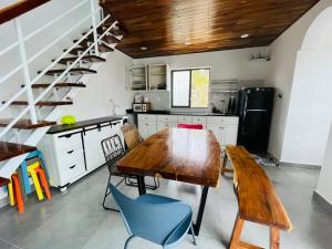 a kitchen with a wooden table and blue chairs at Summer Villa with 3 Bedrooms in Phu Quoc