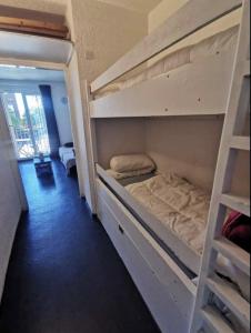 a room with two bunk beds with a ladder at Studio cabine 4 personnes in Les Angles