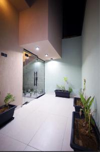 a hallway with potted plants and a glass door at A studio in Al-Murouj self check in in Riyadh