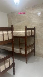 two bunk beds in a room with a wall at Refúgio Sol & Mar in Cabo Frio +48 photos