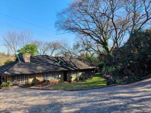a house with a shingled roof on a street at Wag-n-Bietjie in Centurion