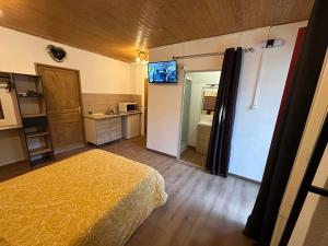 a hotel room with a bed and a bathroom at Imprevu in La Voulte-sur-Rhône