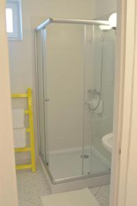 a glass shower in a bathroom with a sink at Jászberény Boutique Room in Jászberény