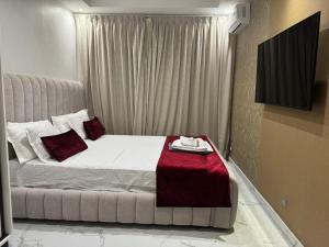 达喀尔Harmony residence dakar的卧室里有一张床，上面铺着一条红毯子