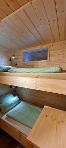a wooden cabin with two bunk beds in it at Chaletwohnung Innerkrems in Innerkrems