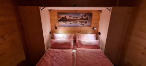 a small room with two bunk beds with pink blankets at Chaletwohnung Innerkrems in Innerkrems