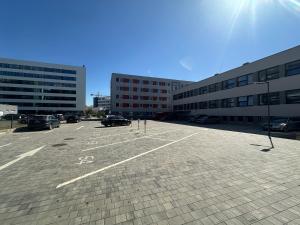 a parking lot with parked cars and buildings at 111Apartments in Košice