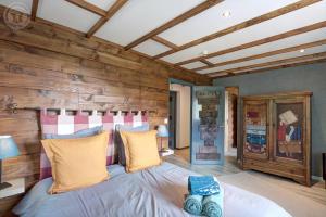 una camera da letto con un letto in una stanza con pareti in legno di Echo des montagnes a Chalmazel Jeansagniere