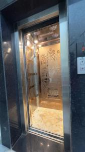 a glass door of a elevator in a building at Home of Backpackers in Jaipur