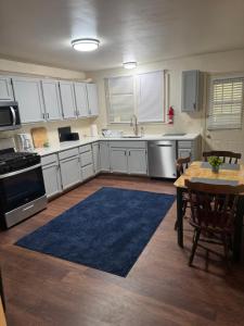 a kitchen with white cabinets and a table with a blue rug at 2 bedroom Saratoga Springs in Saratoga Springs