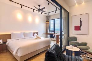 a hotel room with a bed and a chair at 22 Macalisterz by ALV in George Town +37 photos