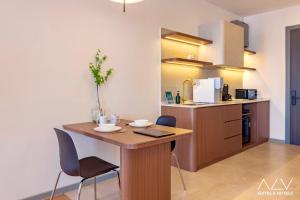 a kitchen with a table and chairs in a room at 22 Macalisterz by ALV in George Town