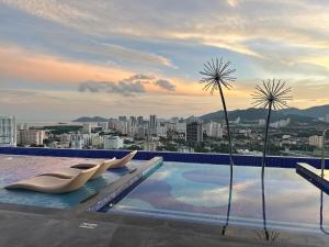 a swimming pool with a view of a city at Cozy studio with Komtar view at 22 Macalisterz in George Town