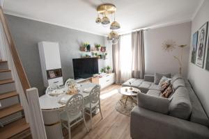 a living room with a couch and a table at The Royal House 102 sqm 2BR Two Floor Apartment in Hunedoara
