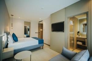 a hotel room with a bed and a tv at Echinus Blue Hotel in Antalya