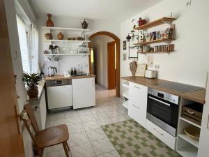 a kitchen with white cabinets and a counter top at Das Grüne Nest in Neckarsteinach +9 photos