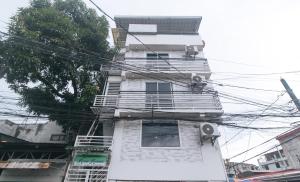 a tall white building with lots of power lines at V-Cloud Hills Boarding House Near NAIA Terminal in Manila