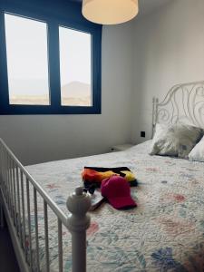 a bedroom with a bed with bags on it at Malpais in Puertito de Güímar +14 photos