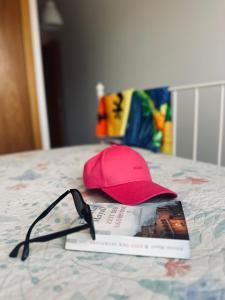 a hat and glasses sitting on a book on a table at Malpais in Puertito de Güímar +14 photos