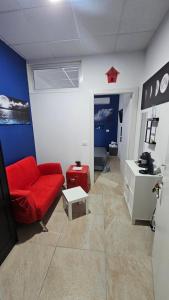 a living room with a red couch and a table at GD House in Tito
