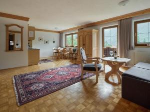 a living room with a couch and a table at Ferienwohnungen Falger in Berwang