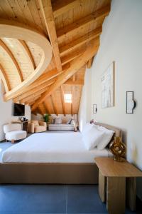 a bedroom with a large bed with wooden ceilings at Sky Room Square View - Bernina Experience in Tirano