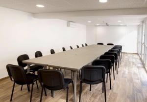 a large conference room with a long table and chairs at Logis Hôtel Restaurant & Spa au Soleil in Wettolsheim +62 photos
