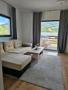 a living room with a couch and a table at Panoramic Chalet Bran in Bran