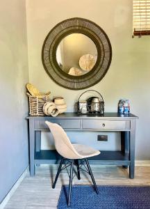 a blue desk with a chair and a mirror at Piers Villa G in Harare