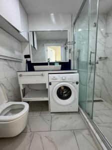 a bathroom with a washing machine and a sink at VIP ORBI city A D C in Batumi +61 photos