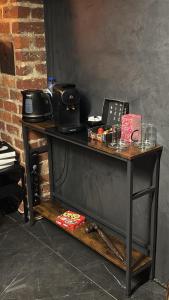 a wooden table with a telephone on top of it at Maison Soleya Brussels, private spa and love room in Asse