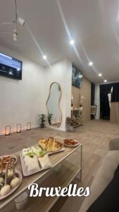 a room with a buffet of food on a table at Maison Soleya Brussels, private spa and love room in Asse
