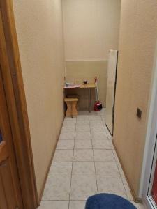 a hallway with a table and a refrigerator in a room at Квартира in Baku