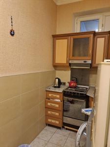a kitchen with a stove and a microwave at Квартира in Baku