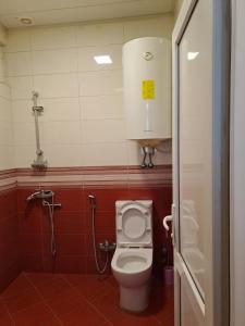 a bathroom with a toilet and a shower stall at Квартира in Baku +2 photos