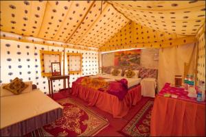 a bedroom with two beds in a room at Royal Gadhvi Desert Camp in Sām