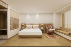 a bedroom with a white bed and a couch at Lemon Tree Premier, Tirupati in Tirupati