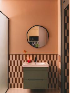 a bathroom with a sink and a mirror at Saint J Hotel by Brassbell in Cairo +164 photos