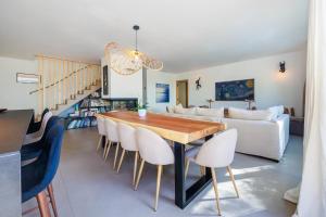 una sala da pranzo e un soggiorno con tavolo e sedie di Villa Cosy Neuve 8 min à pieds des plages a Cassis