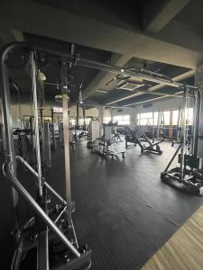 a gym with rows of treadmills and machines at Fumba Town Tausi Apartments in Zanzibar City