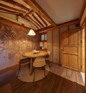 a dining room with a wooden table and chairs at Luxury Hanok Heritage Courtyard in Seoul