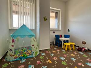 a childs play room with a play tent and a table at Hotel ILF in Prague