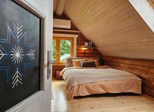 a bedroom with a bed and a chalkboard on the wall at 2-bedroom, fenced yard, sauna, 10 min to Pärnu in Pärnu