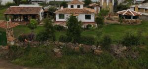 an aerial view of a house with a yard at POSADA VILLA DEL ROSARiO in Sutamarchán +2 photos